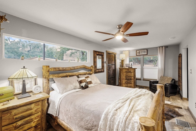 bedroom with multiple windows and ceiling fan