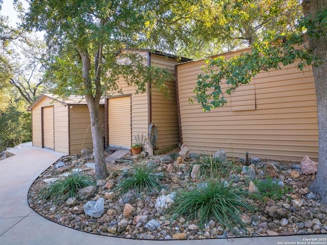 view of home's exterior with a storage unit