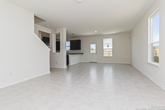 unfurnished living room with light tile patterned flooring