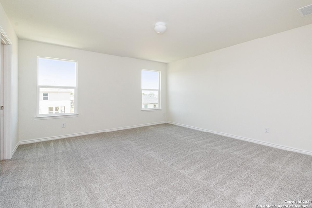 carpeted empty room featuring a healthy amount of sunlight