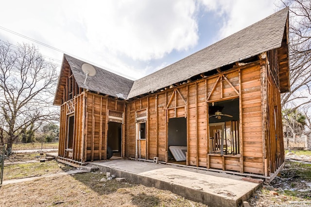 rear view of house featuring ceiling fan