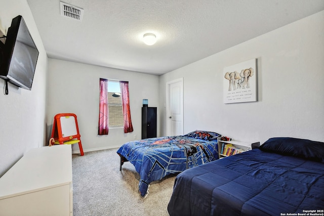 bedroom featuring carpet and a textured ceiling