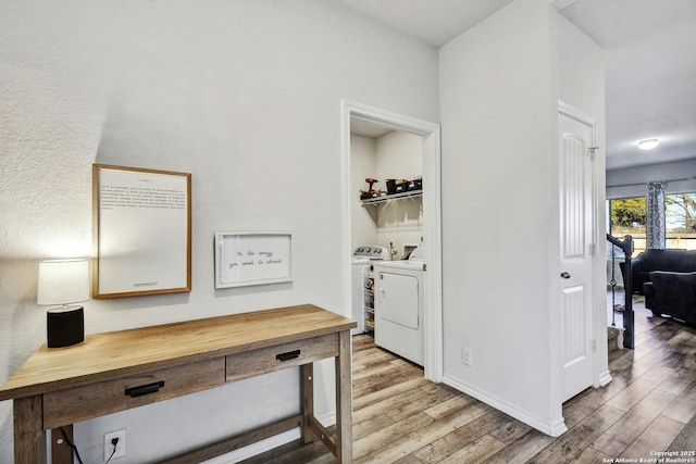 hall featuring hardwood / wood-style flooring and washing machine and dryer