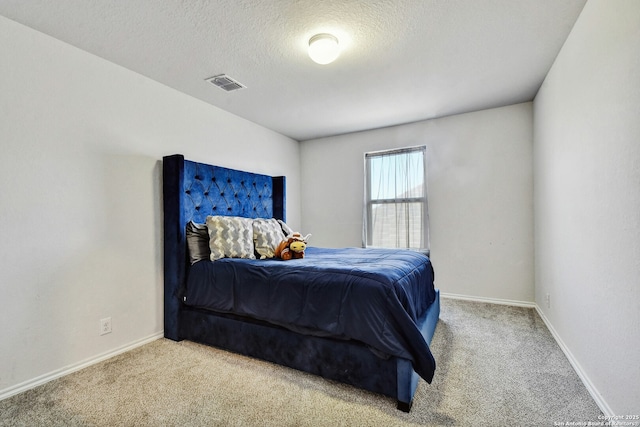 carpeted bedroom with a textured ceiling