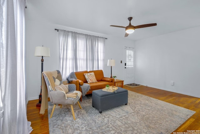 living room featuring hardwood / wood-style floors and ceiling fan