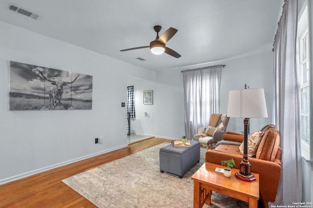 living room featuring hardwood / wood-style flooring and ceiling fan