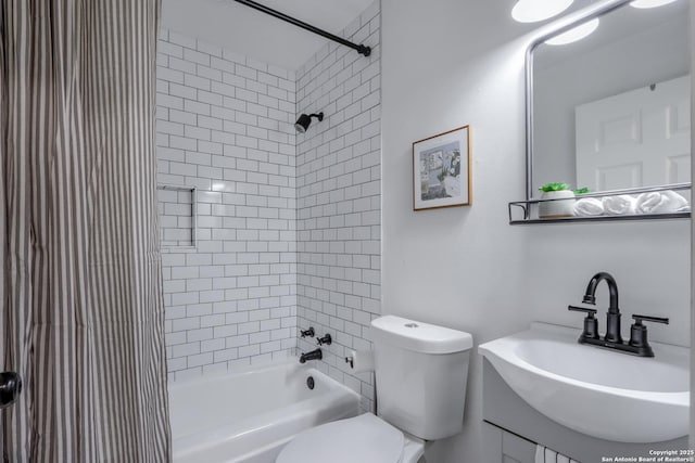 full bathroom featuring tiled shower / bath, sink, and toilet