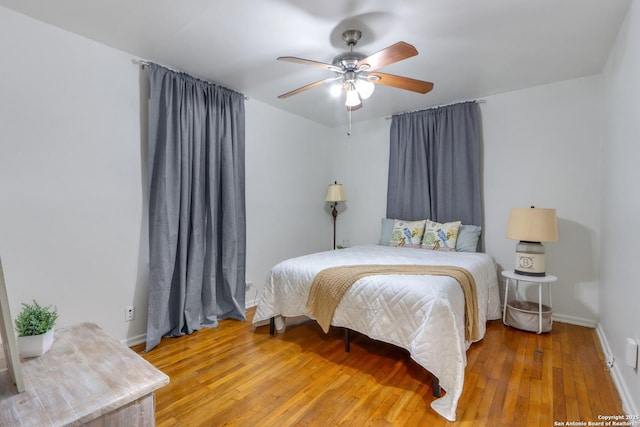 bedroom with hardwood / wood-style flooring and ceiling fan