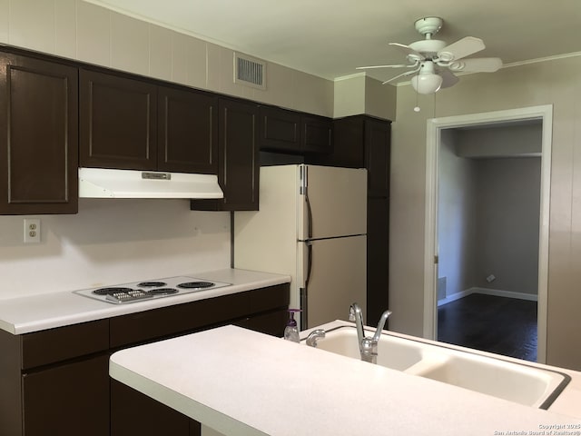 kitchen with sink, white appliances, dark brown cabinets, and ceiling fan