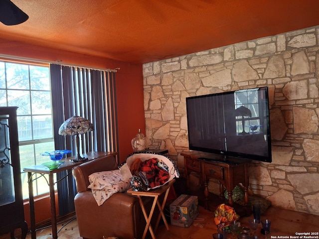 living area featuring a textured ceiling