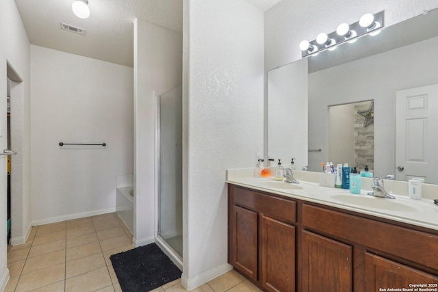 bathroom featuring vanity, shower with separate bathtub, and tile patterned flooring