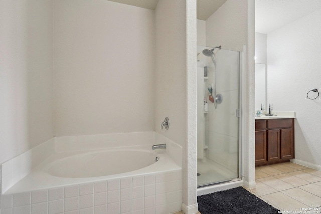 bathroom featuring shower with separate bathtub, vanity, and tile patterned floors