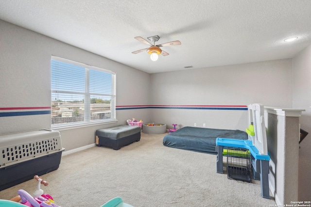 bedroom featuring ceiling fan, carpet flooring, and a textured ceiling