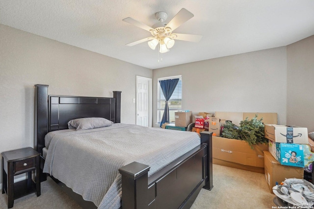 bedroom featuring light carpet and ceiling fan