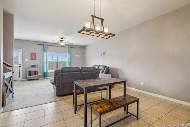 tiled living room with ceiling fan with notable chandelier