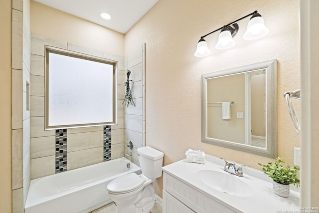 full bathroom featuring vanity, tiled shower / bath combo, and toilet