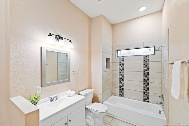 full bathroom featuring vanity, tiled shower / bath, tile patterned flooring, and toilet