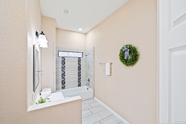 bathroom with tiled shower / bath and tile patterned floors