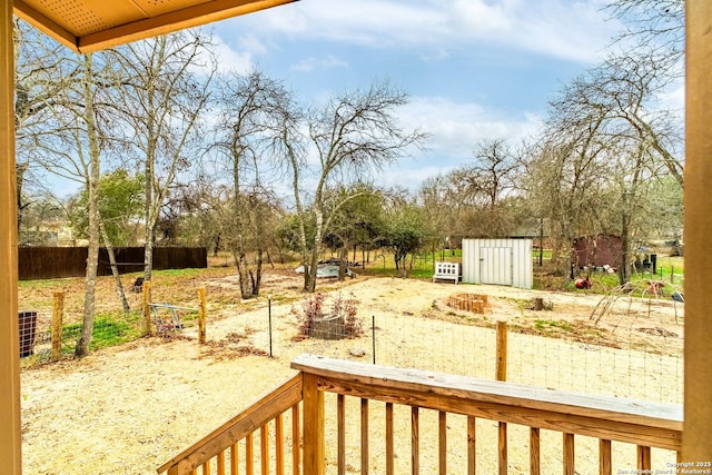 view of yard with central AC and a storage unit