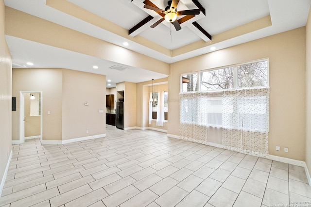 empty room featuring coffered ceiling, ceiling fan, and beam ceiling