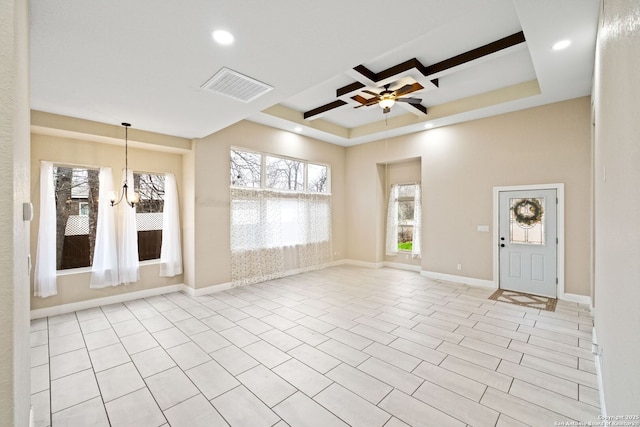 spare room with coffered ceiling, ceiling fan with notable chandelier, and a towering ceiling