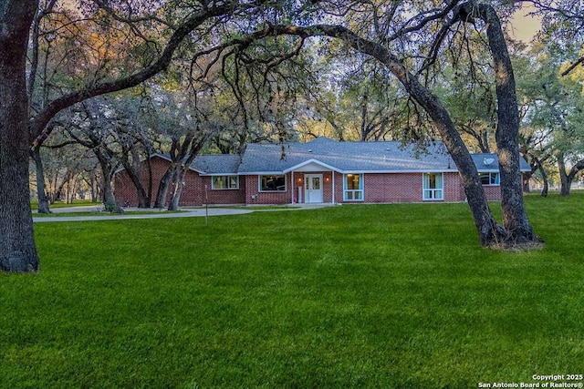 ranch-style house with a lawn