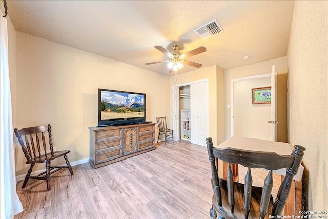 interior space with ceiling fan and light hardwood / wood-style flooring