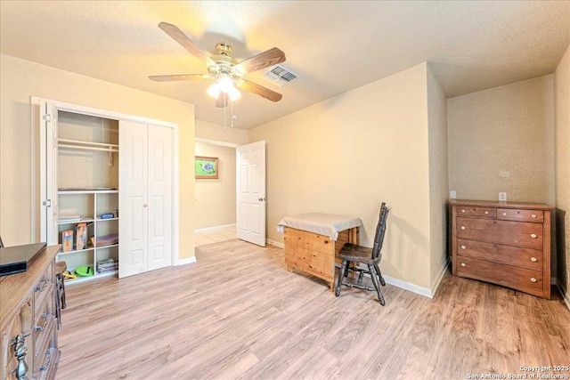 office space featuring ceiling fan and light hardwood / wood-style floors