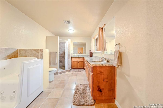 bathroom featuring tile patterned floors, vanity, toilet, and a shower with door