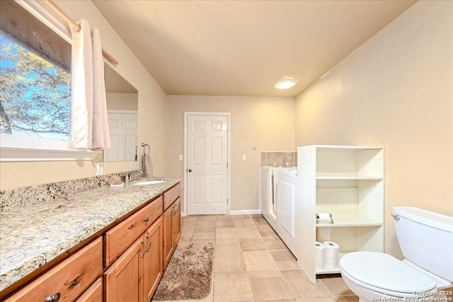 bathroom featuring vanity, toilet, and tile patterned flooring