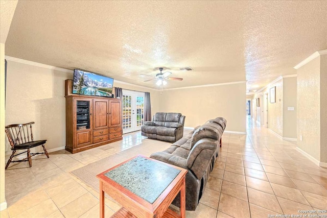 tiled living room with a textured ceiling, ornamental molding, french doors, and ceiling fan