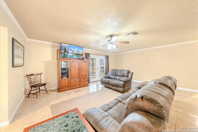 living room featuring light tile patterned flooring, crown molding, and a textured ceiling