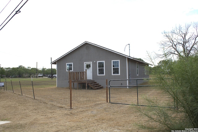 rear view of property with a lawn