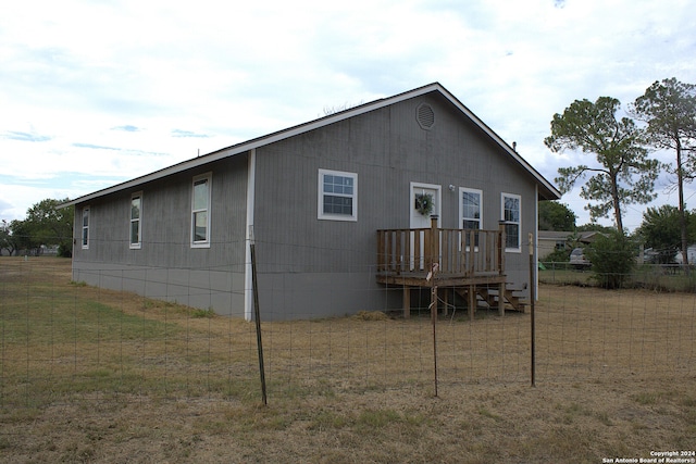 rear view of house featuring a lawn
