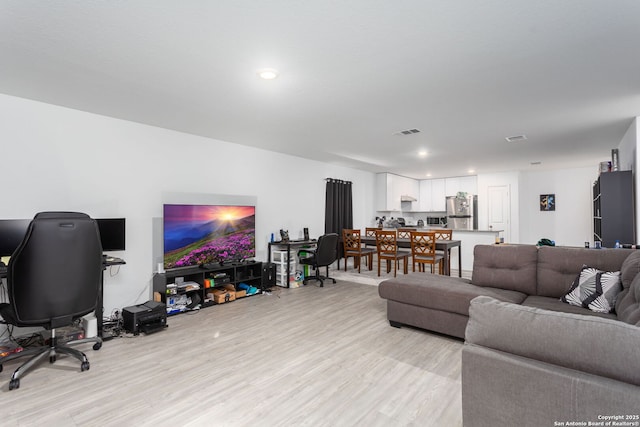 living room with light hardwood / wood-style floors