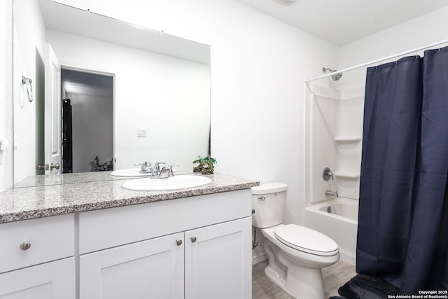 full bathroom featuring vanity, wood-type flooring, shower / bath combination with curtain, and toilet