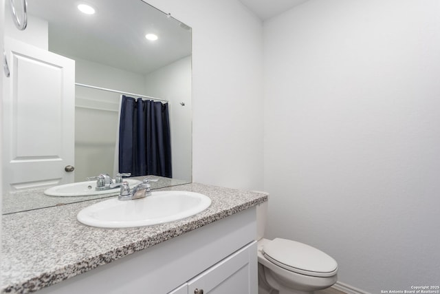 bathroom with vanity, toilet, and walk in shower