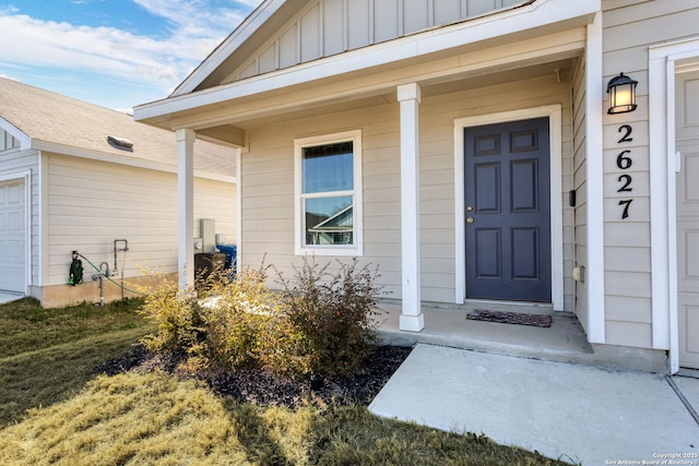 property entrance with a garage and covered porch