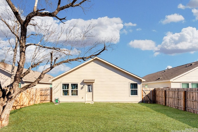 rear view of property with a yard