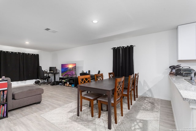 dining space featuring light hardwood / wood-style floors