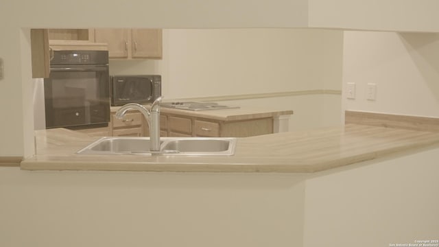 kitchen featuring sink, black appliances, and light brown cabinets