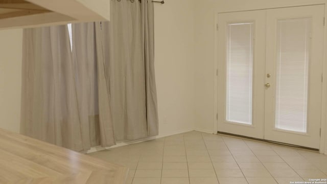 tiled spare room with french doors