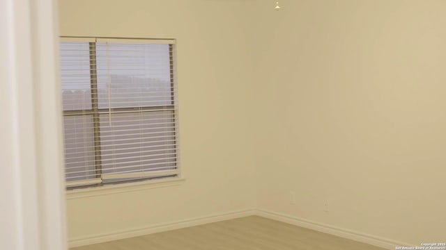 unfurnished room with wood-type flooring