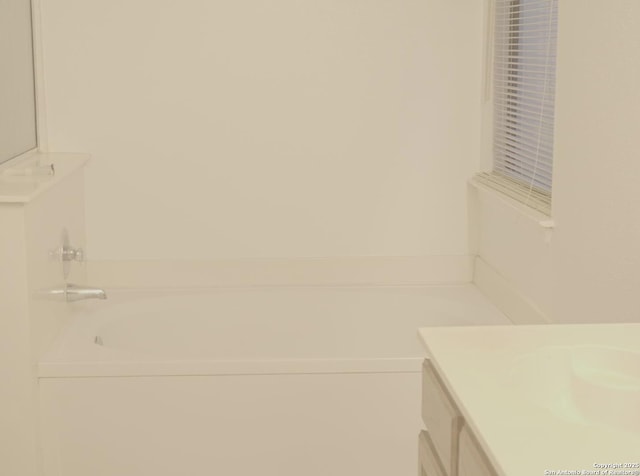 bathroom with vanity and a bathtub