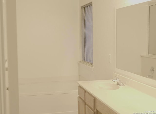 bathroom with vanity and a tub to relax in