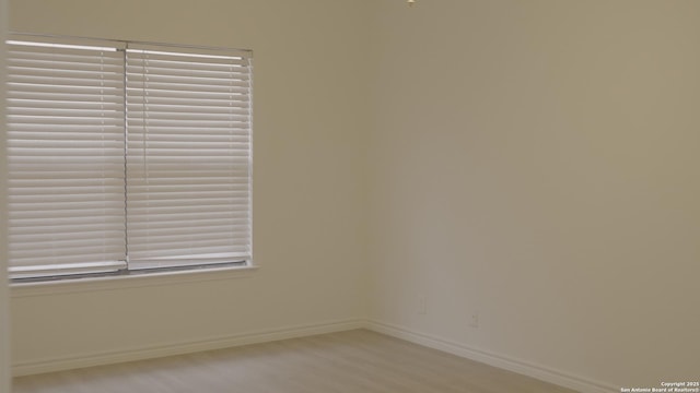 unfurnished room with light hardwood / wood-style flooring