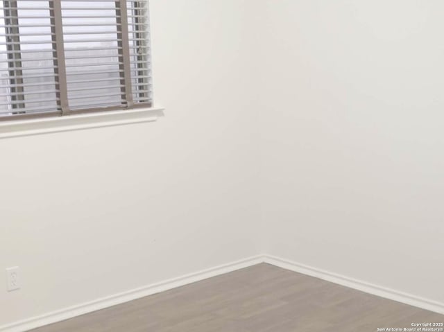 spare room with hardwood / wood-style flooring