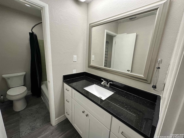 full bathroom featuring toilet, wood-type flooring, shower / bathtub combination with curtain, and vanity