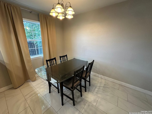 dining space with an inviting chandelier