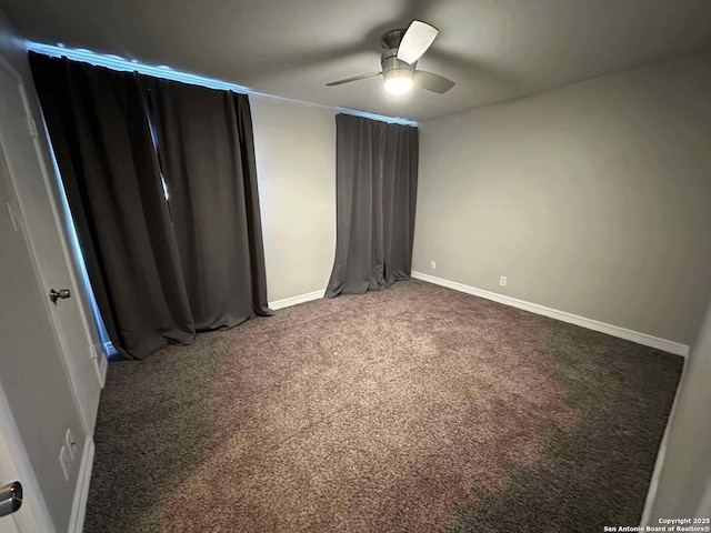 unfurnished bedroom featuring ceiling fan and carpet